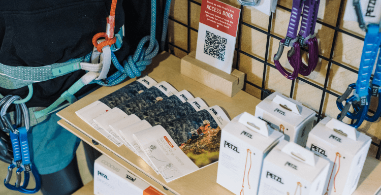 Petzl brochures and climbing gear displayed on a shelf