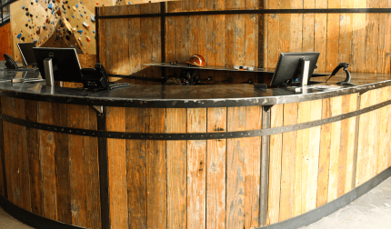 A reclaimed wood desk with a metal top