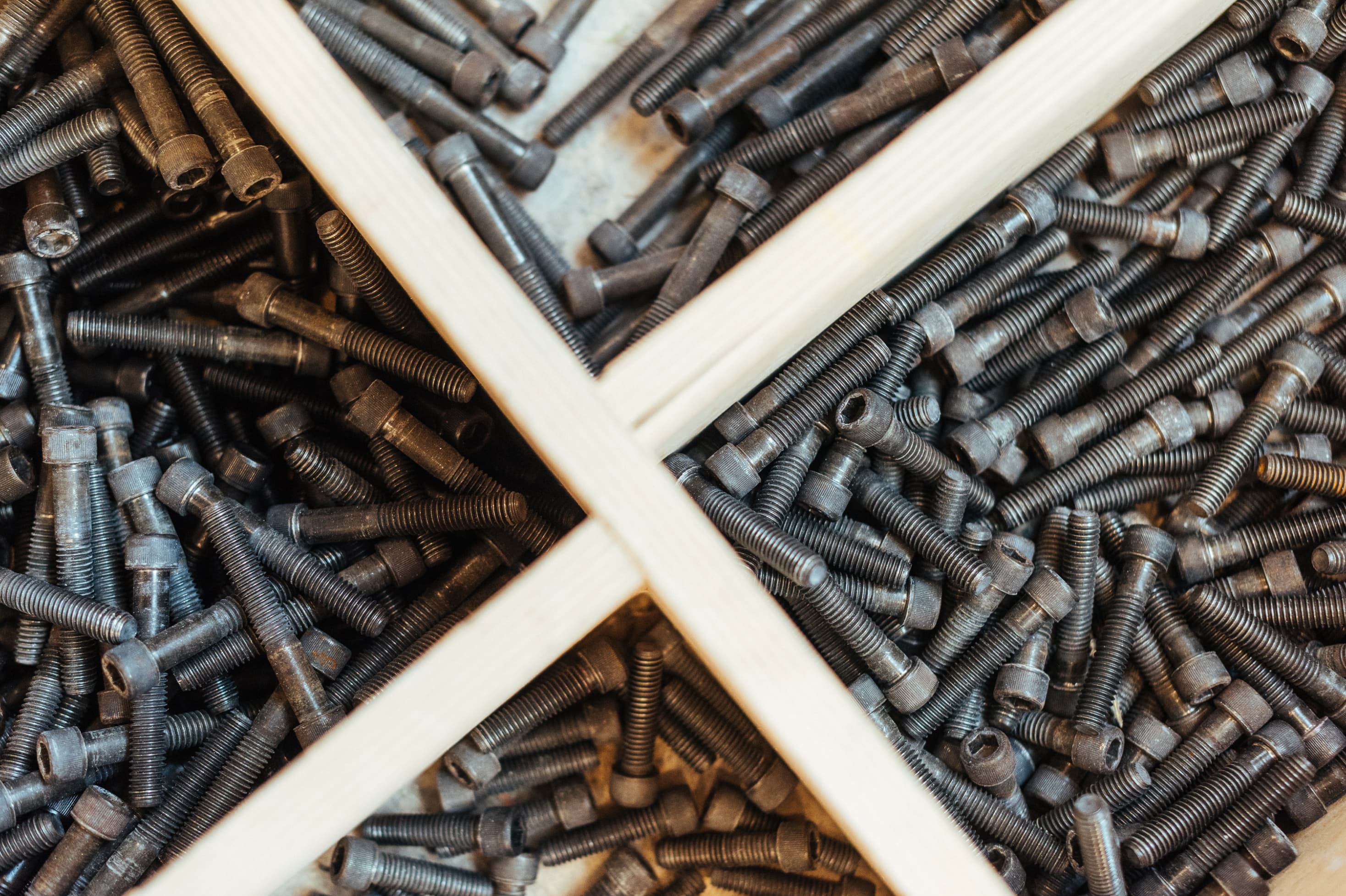 Climbing bolts organized in trays available at Proxy Climbing