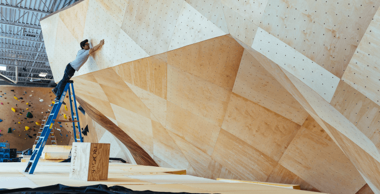 Man inspecting refinished bouldering walls