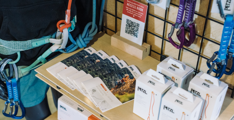Petzl brochures and climbing gear displayed on a shelf