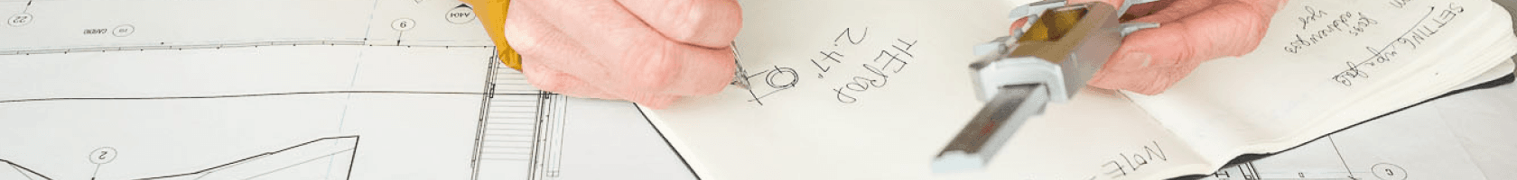 A drafter makes notes on blueprints