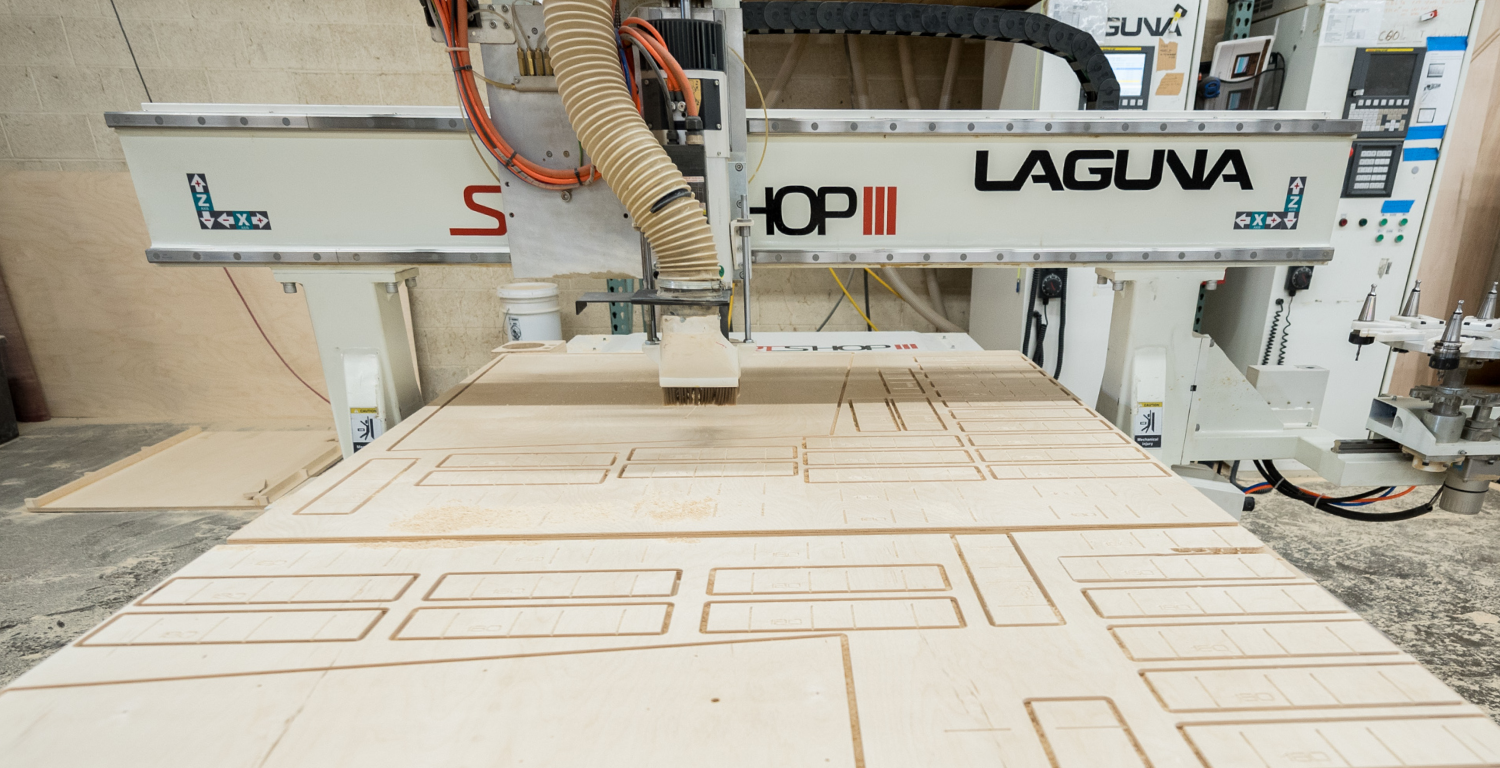 CNC machine cutting out pieces for rock climbing gym construction