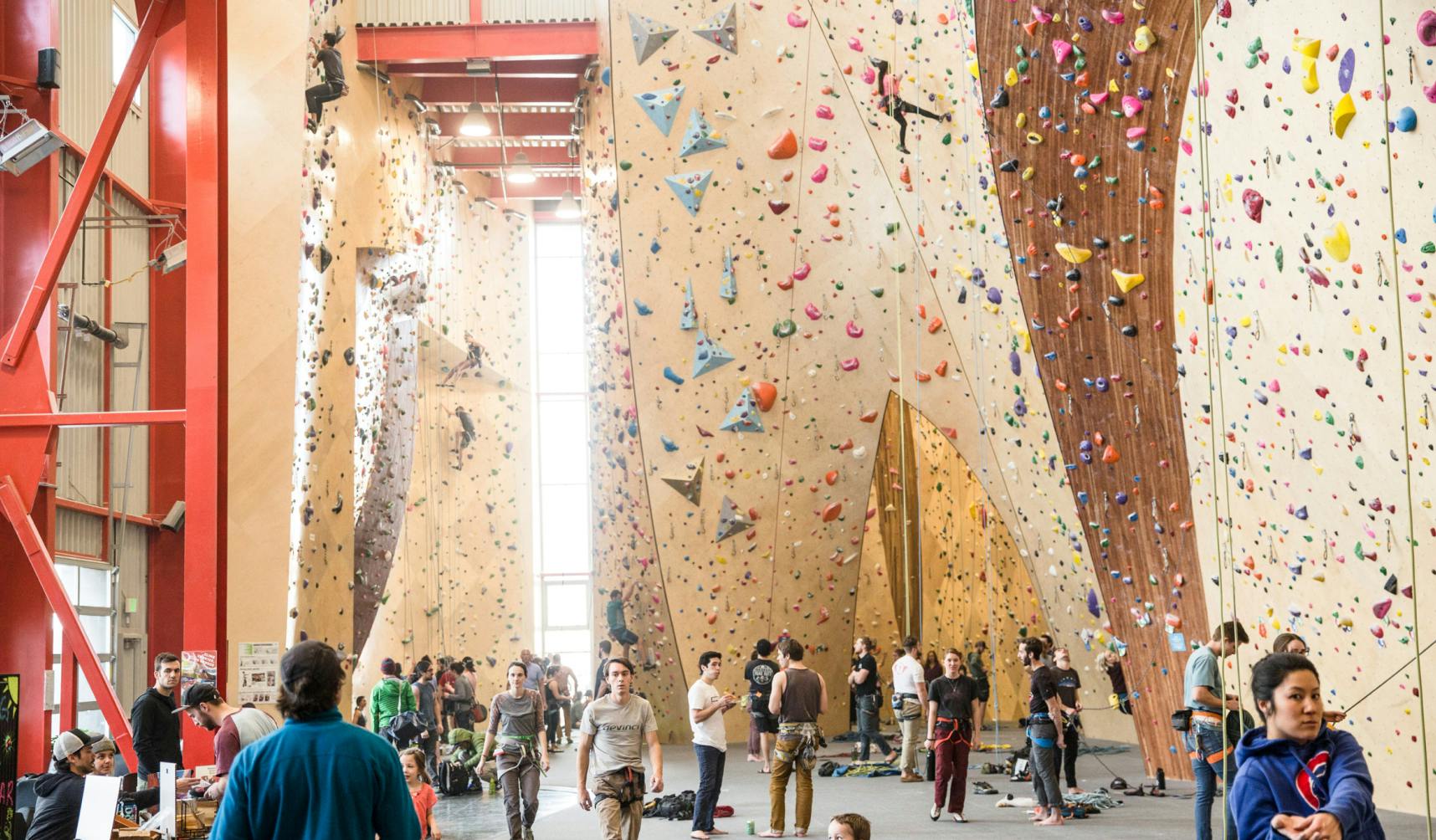 Indoor climbing gym full of people
