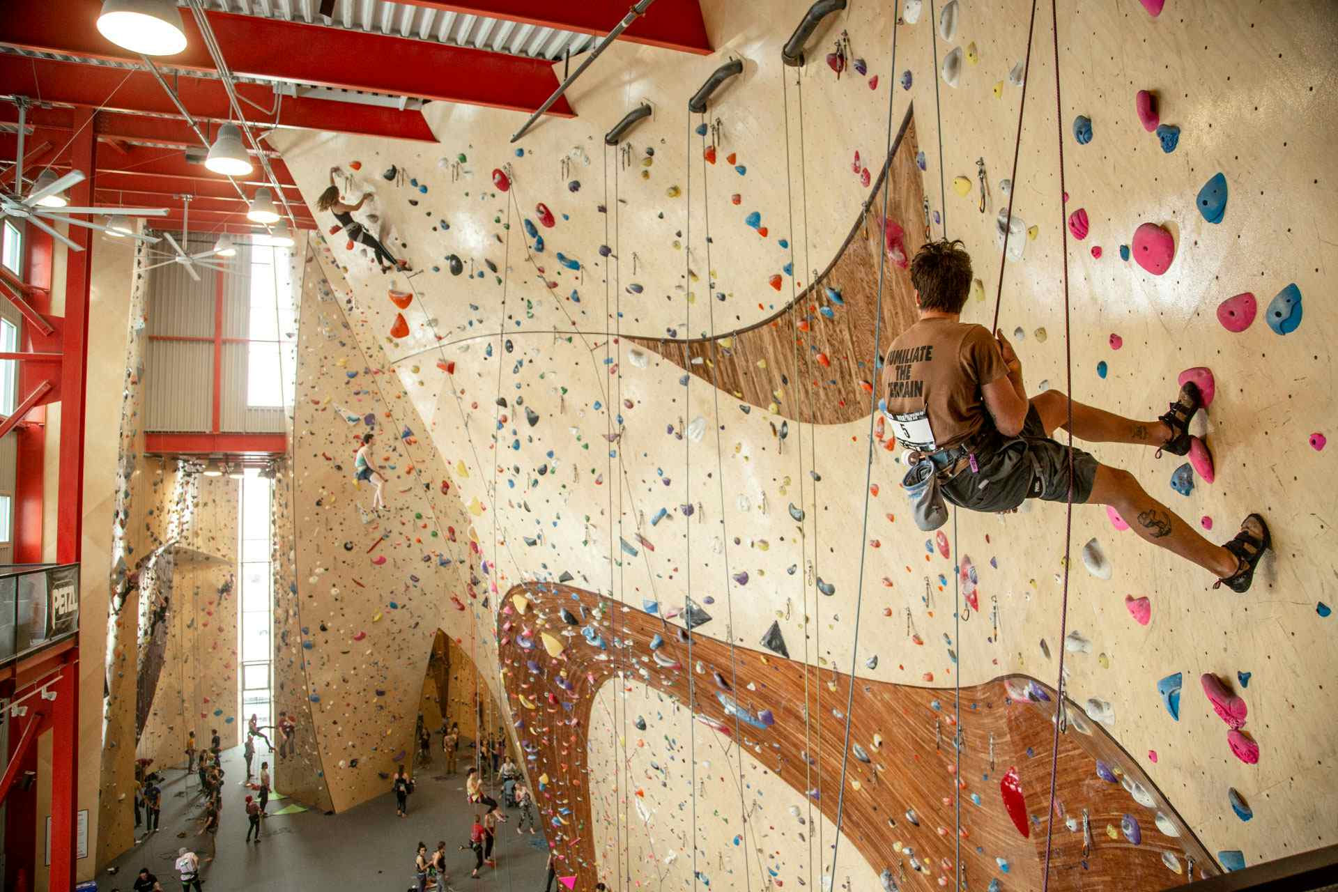 Climbers resting on a large ARC climbing wall at The Front and built by Vertical Solutions