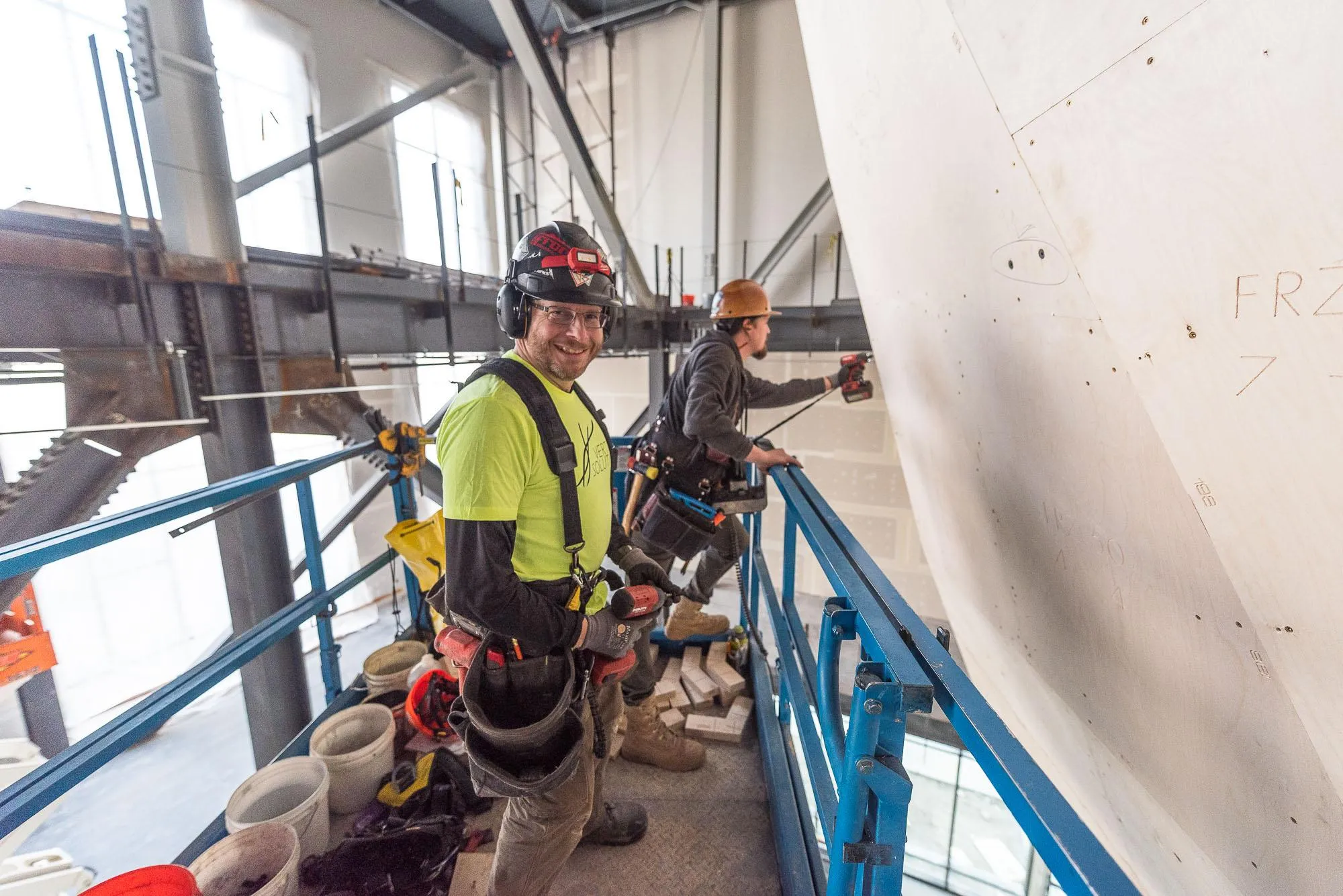 Vertical Solutions crew members installing climbing walls on a lift