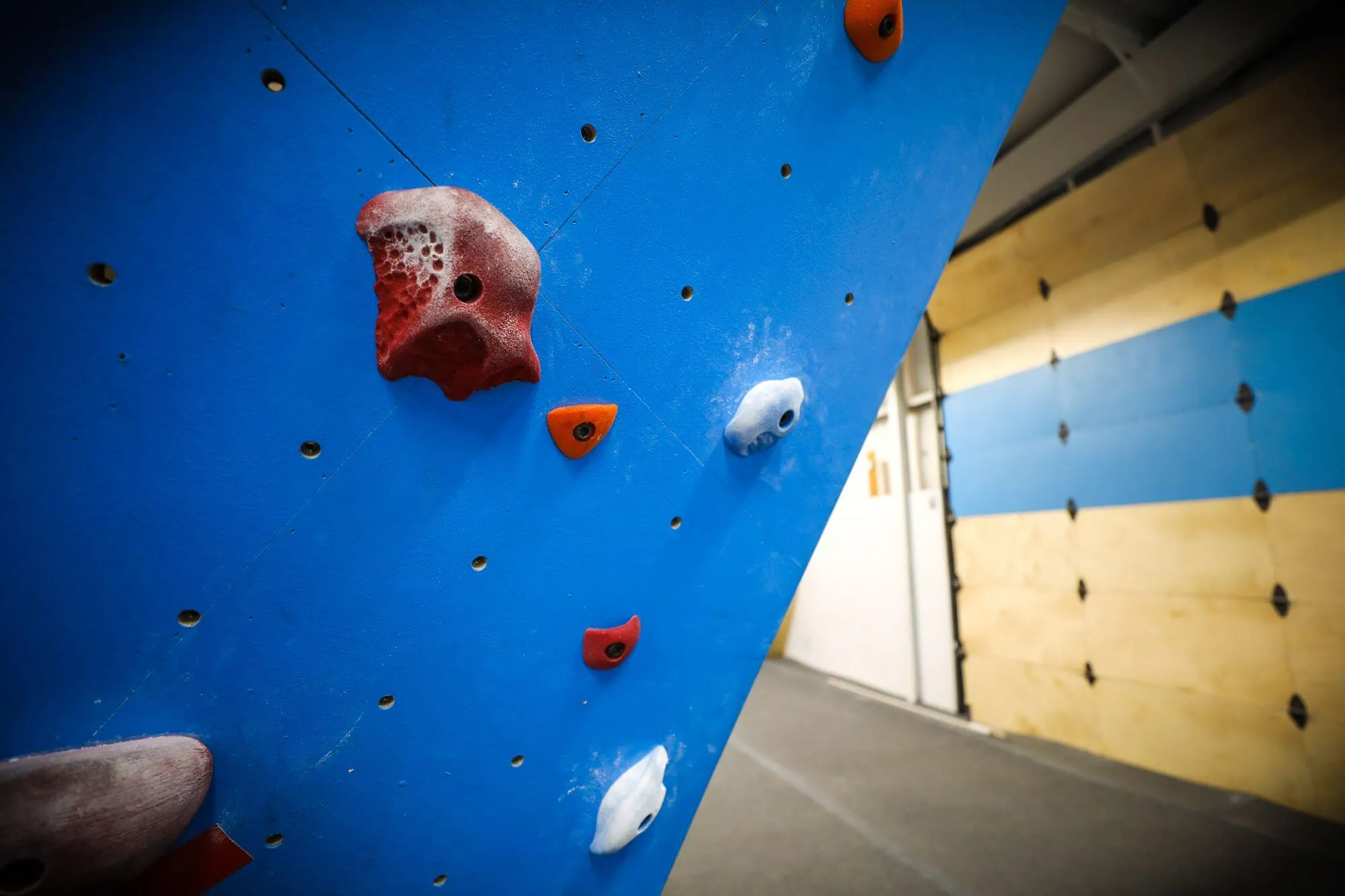 A detail shot of the Funnel Boulder, up-close and personal showing the texture that was chosen by the owner to produce ample grip for difficult problems. It may not look like much, but Vertical Solutions can supply any level of grip you want in custom stains and paints for your climbing walls.
