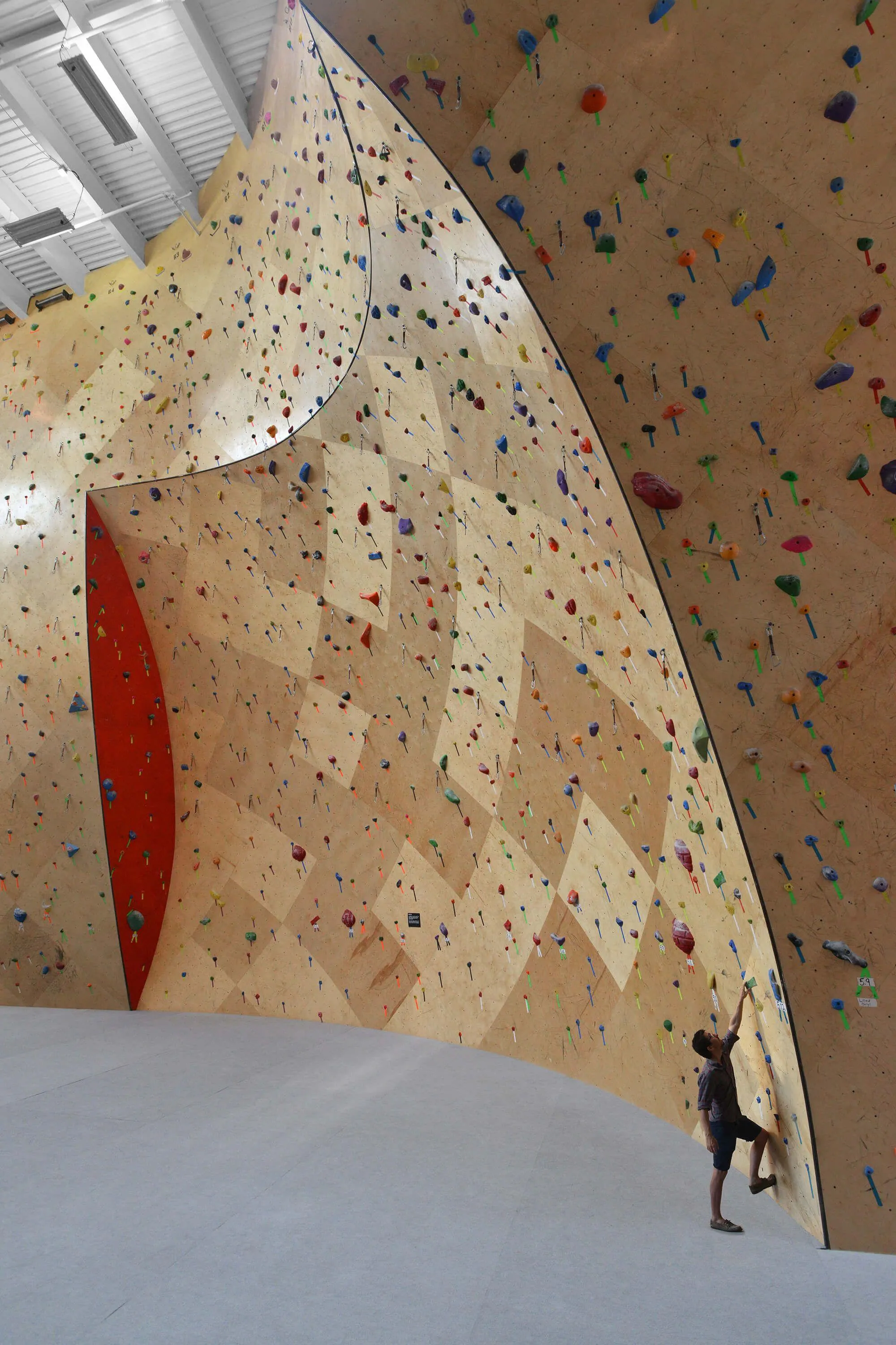 From the bottom of a long lead route on these curved ARC walls, the route seems easily doable. What climbers don’t anticipate is the gradual but challenging increase in overhang angle, which the ARC design masks so easily.
