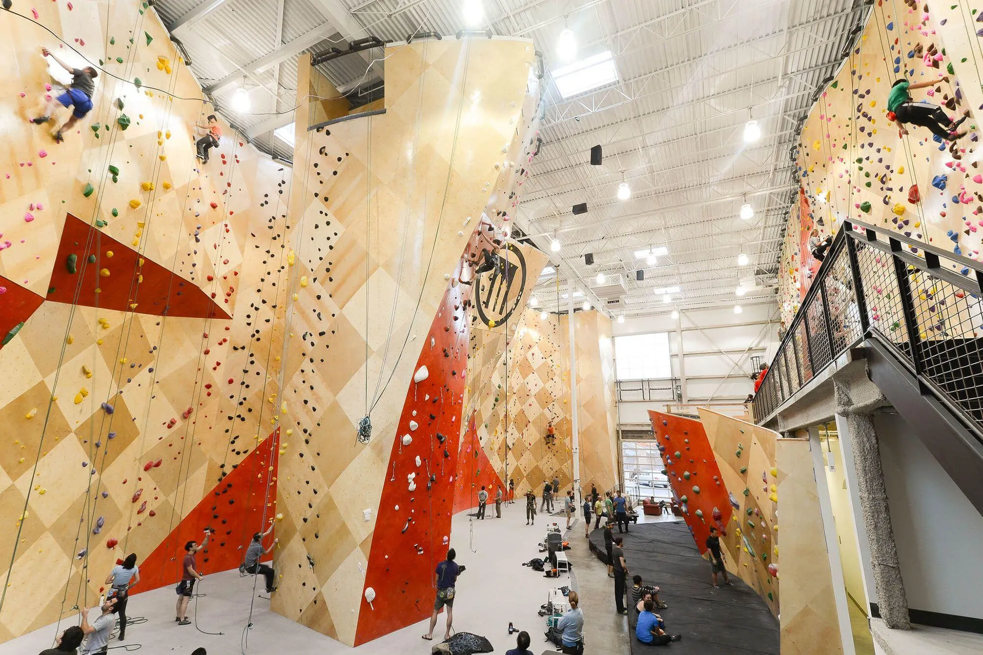 This wide-angle shot shows a large section of the main climbing area, complete with BKB super-large logo and brand-specific red wall stains to accentuate the climbing wall design features. 
