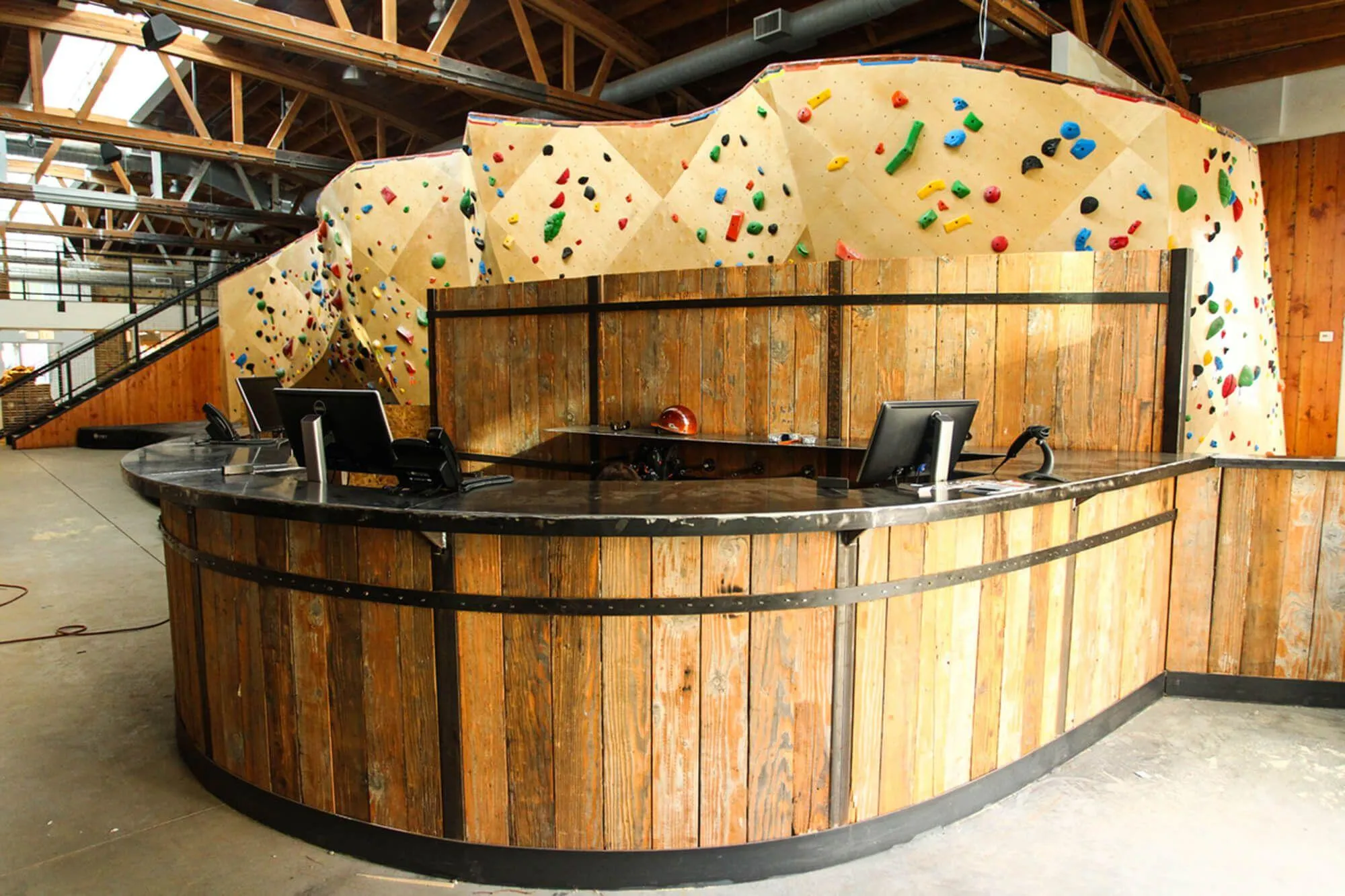 Even the front desk got special Vertical Solutions treatment with a custom design that matches the motif throughout. Exposed hardwood roof beams tie the whole facility together, and the view you get upon entering this facility is a knock-out. Exactly what you want your customers to see every time they walk through your doors.
