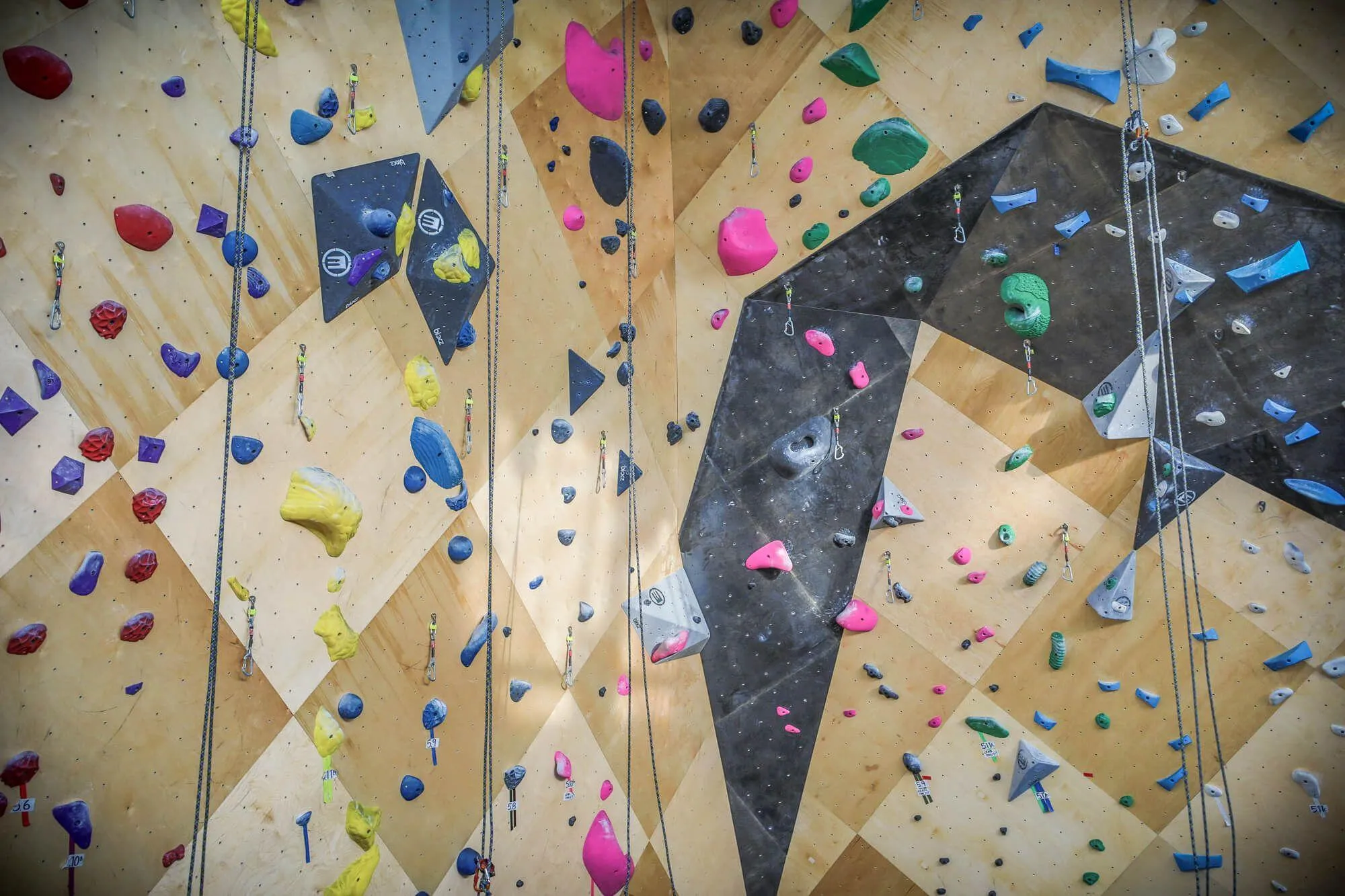 A closer view of the newly renovated indoor route climbing walls from Vertical Solutions. Hard to see from this angle but the custom black stain highlights a crafty overhung feature. 
