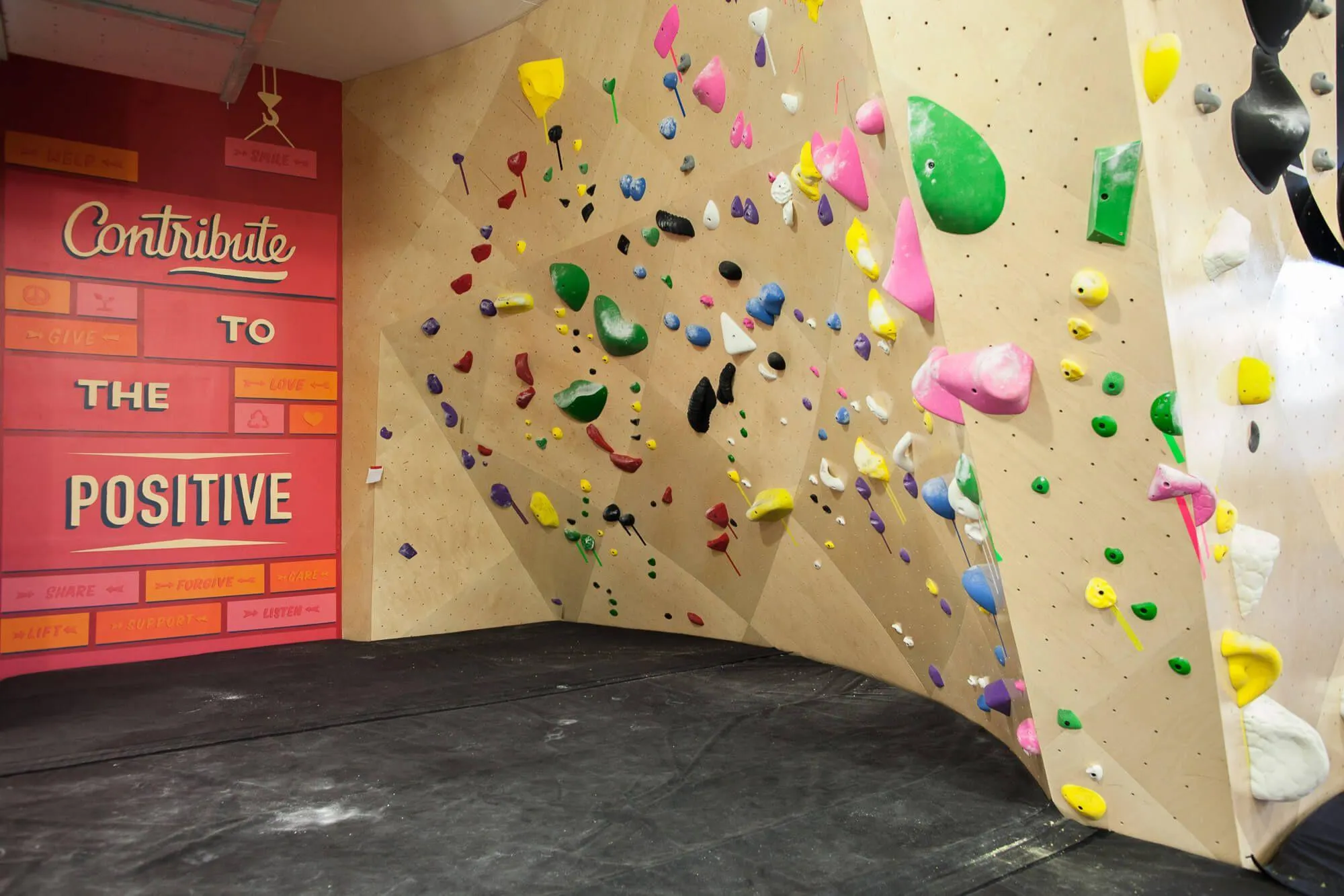 This picture details smart features like this mini-cave climbing wall setback, contribute to the variety of climbing square footage incorporated into this facility.
