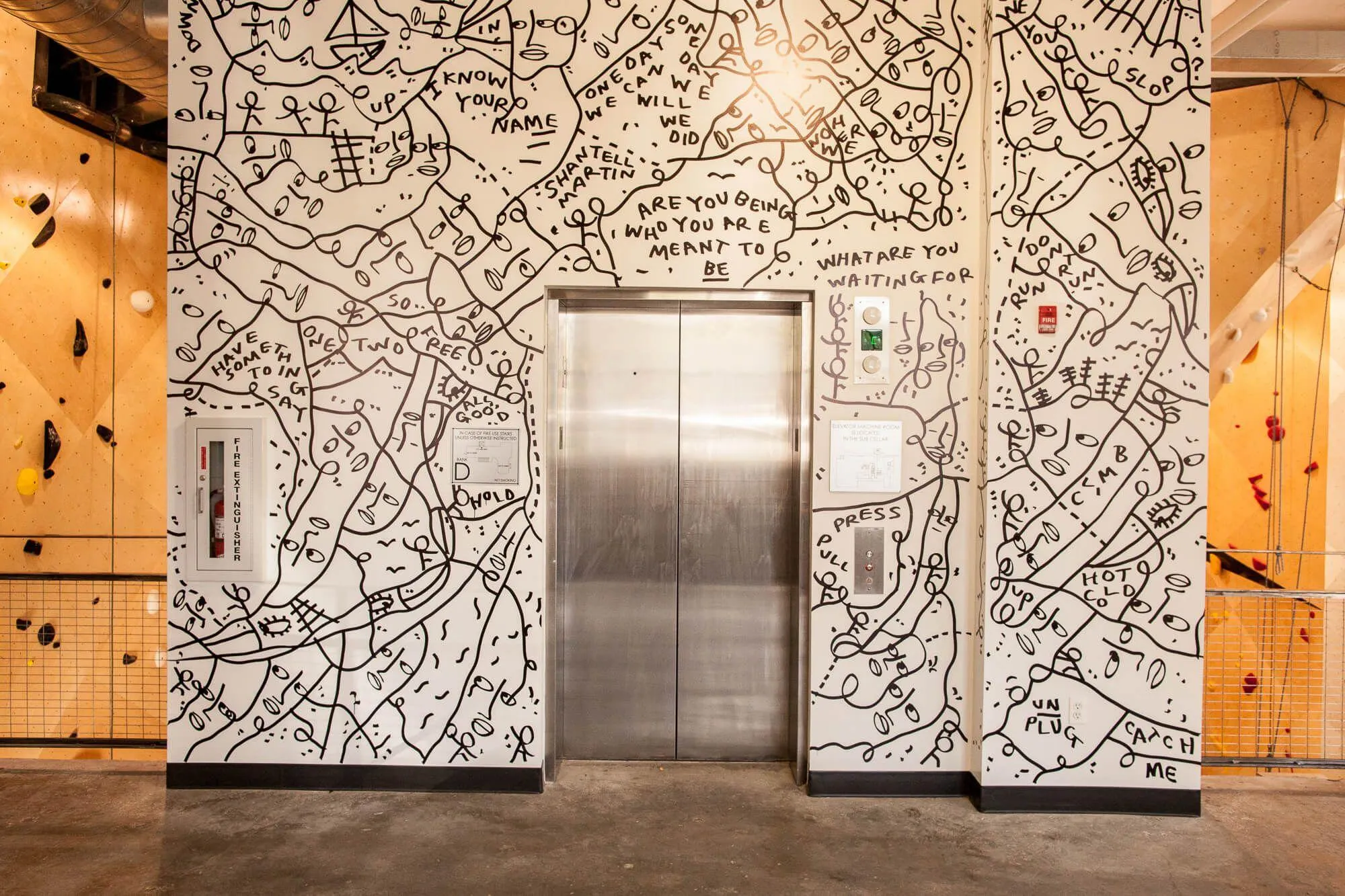 A cool part of the space, the elevator by the front entrance has climbing on the back side and from this level you can see how the rope-climbing walls were accomplished by starting below ground level and working upwards.
