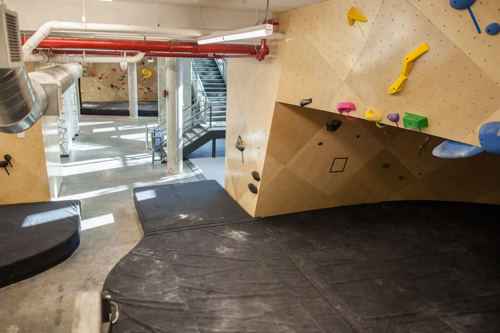 A view looking towards the center of the lower level, standing next to the deep bouldering cave. Designing and manufacturing around the entire building’s support structure was challenging, but not out of our scope of capability.
