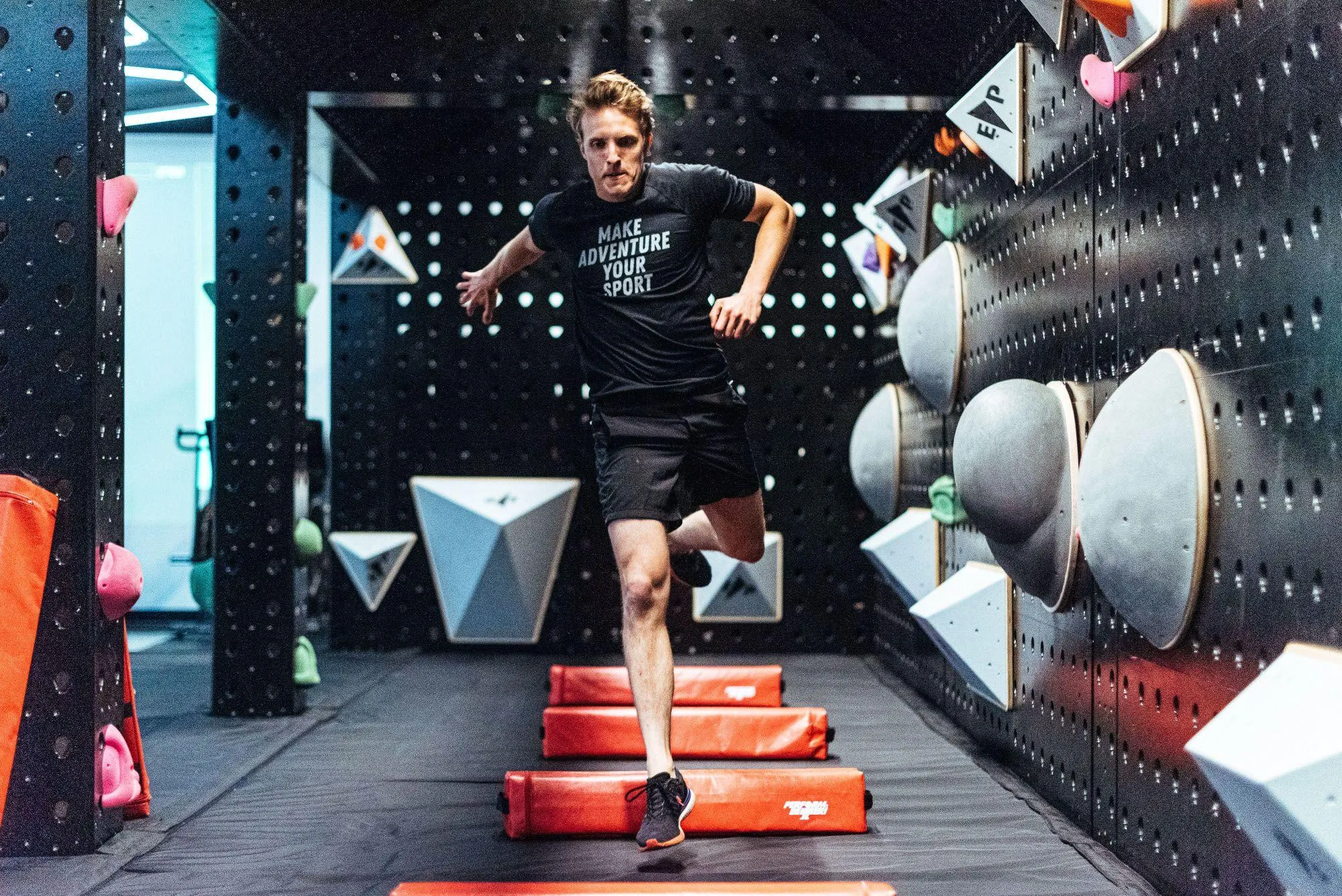 The Adventure Studio matches the bouldering area perfectly with black walls and colorful accents.