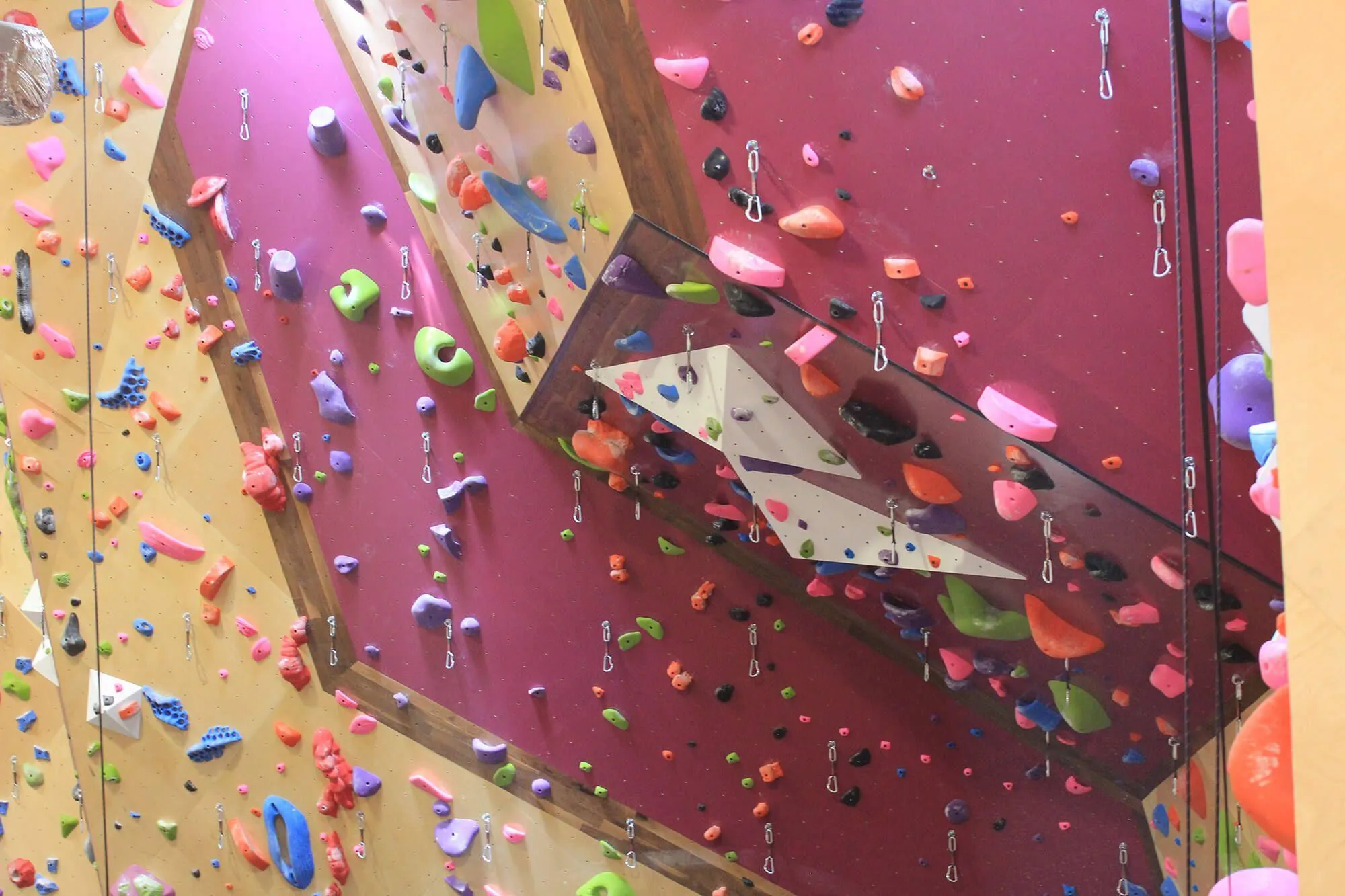 Another great view of the MLM rope climbing walls at Crux. Seen here are all the details the owners wanted to work in, including exposed hardwood, natural birch finished panels and custom stained/painted panels.
