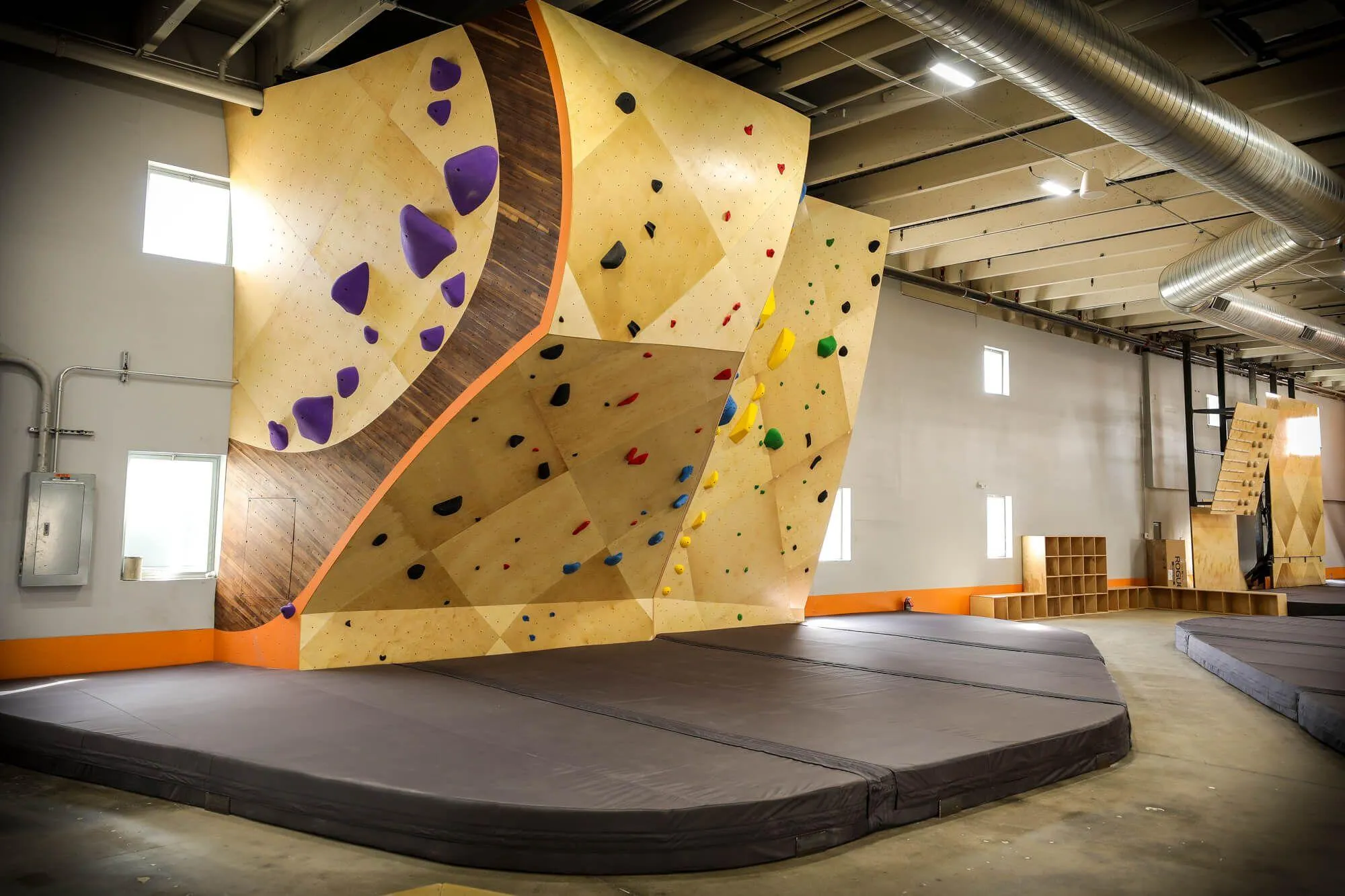 The owners of this climbing gym opted for a mixture of ARC and MLM climbing wall construction, with a gorgeous overhung building-anchored ARC boulder seen here, with flawless Habit Flooring installed beneath.
