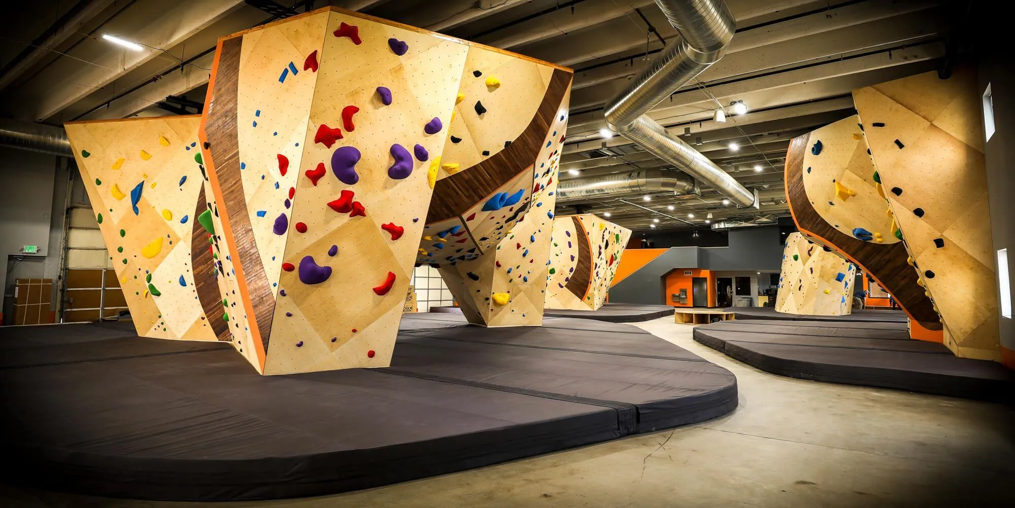 The use of hardwood accents on the climbing walls at this gym is one its most defining brand characteristics.