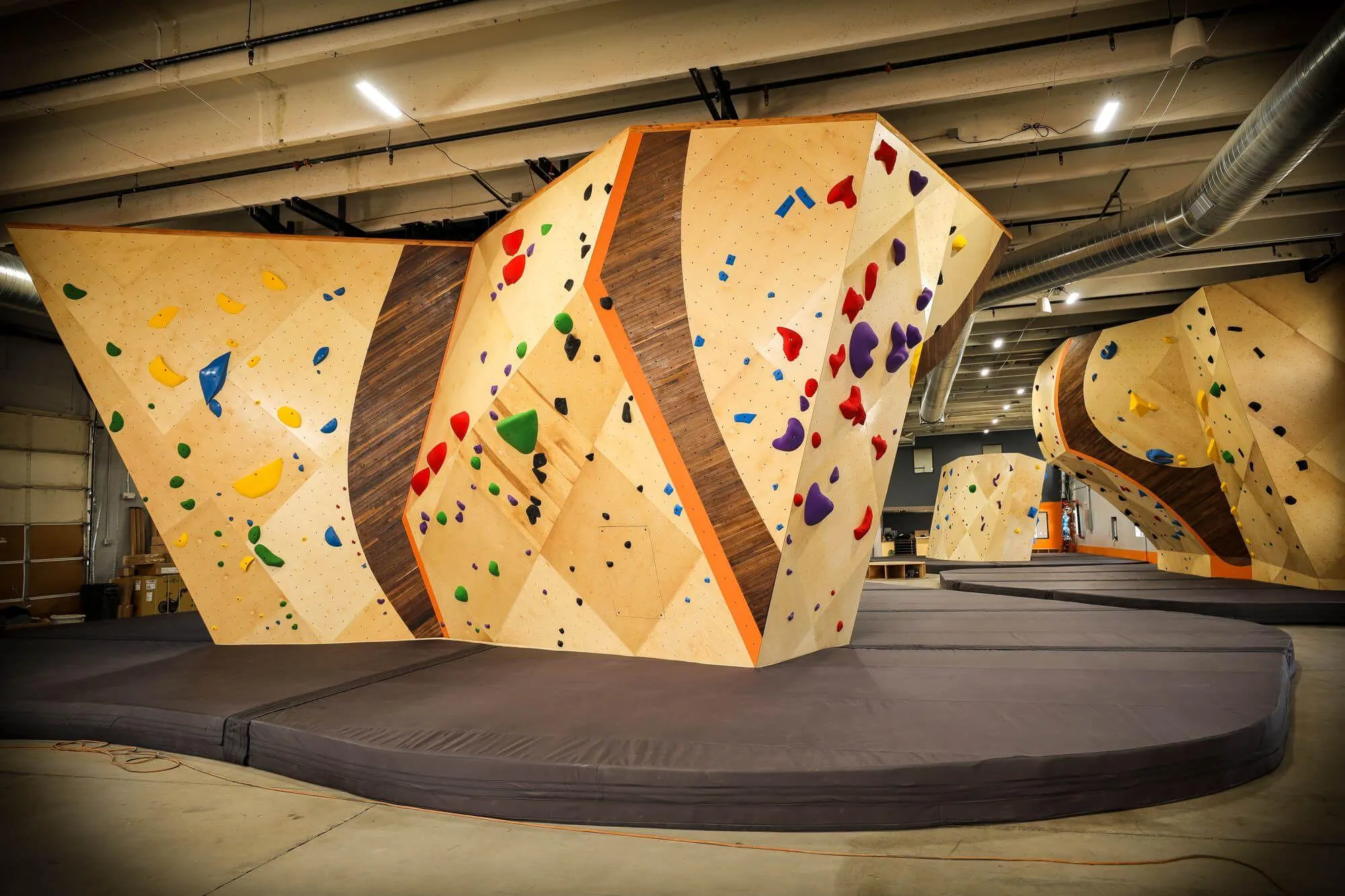 This facility is impressive front-to-back. Utilizing a combination of freestanding and building-anchored climbings walls, as well as MLM and ARC construction, in addition to four total adjustable climbing walls, this gym creates something interesting around every corner.