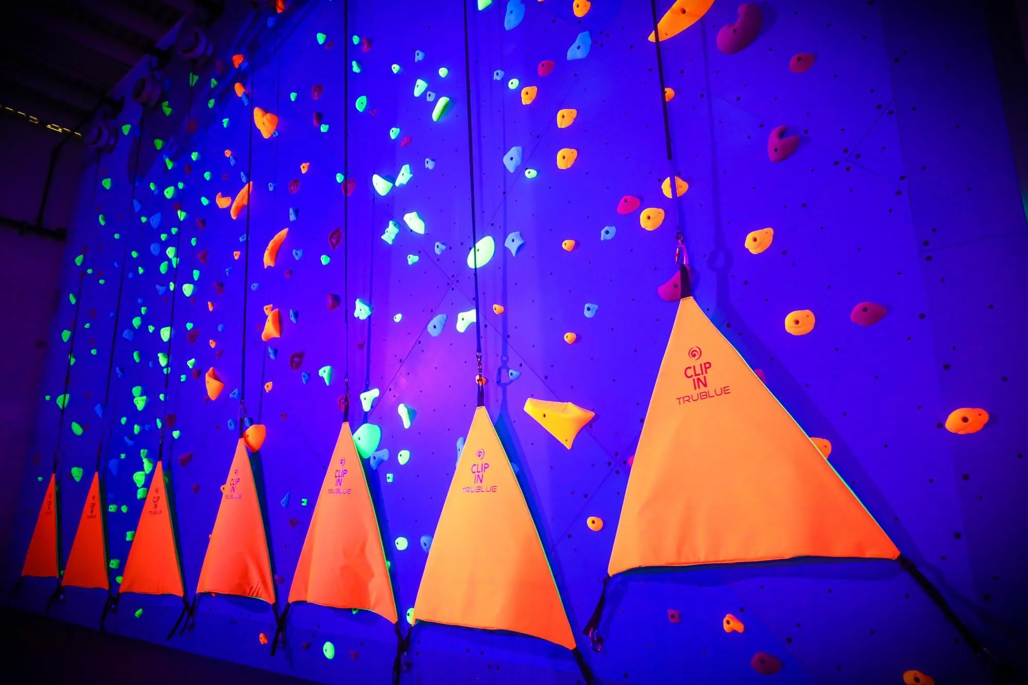 The TruBlue Auto Belays look great under blacklight at this facility. Vertical Solutions is partnered with Head Rush Technologies to give our clients the best solutions for climbers of all ages and skill levels. We typically package these units in together with our walls, floors and holds for discounted pricing on the entire build-out.
