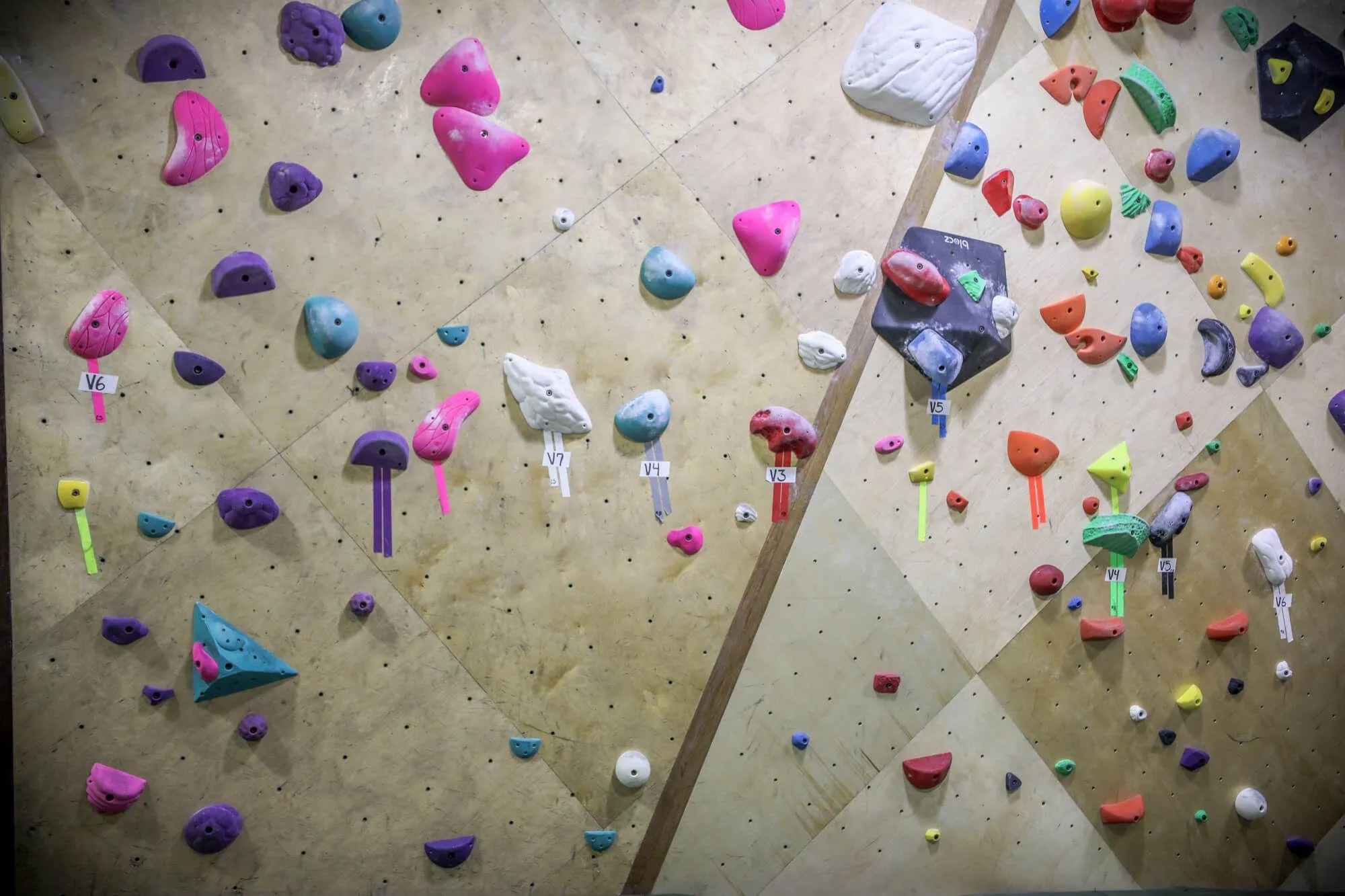 An up-close picture of how Vertical Solutions likes to tackle wall transitions between features. This hardwood treatment adds extra aesthetics and visual definition to the climbing wall design without being overstated.
