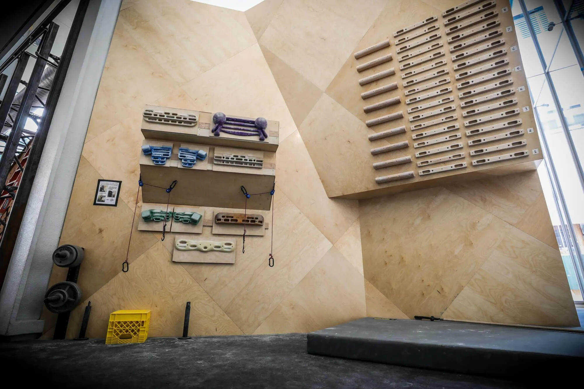 Even in a tight space you can still incorporate room for training systems, as seen here where the backside of the lower bouldering area was designed to accommodate exactly that.
