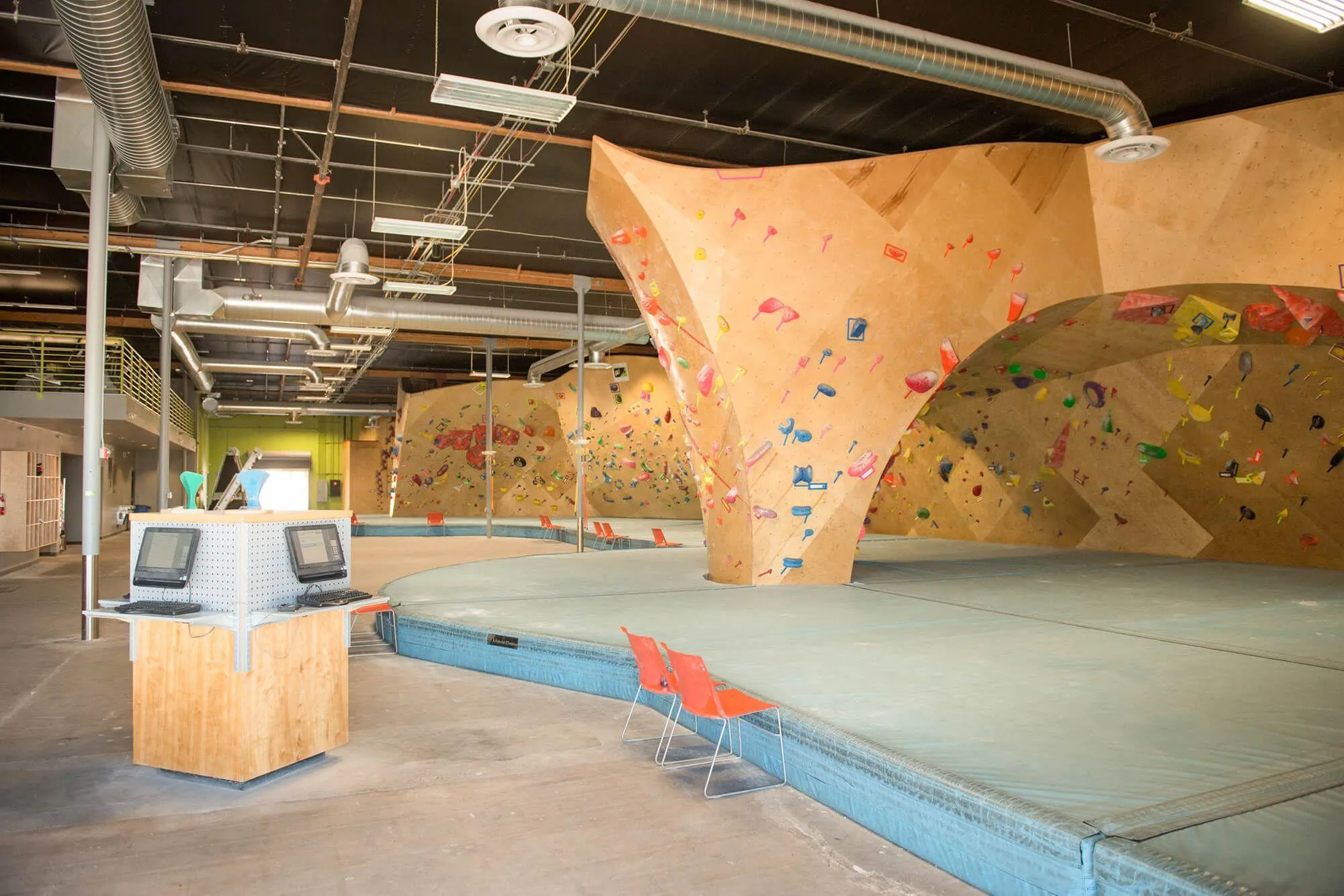 This indoor climbing gym is much bigger than pictures make it seem. This view shows how airy and open it was built to be, for indoor rock climbing, socializing and hosting events.
