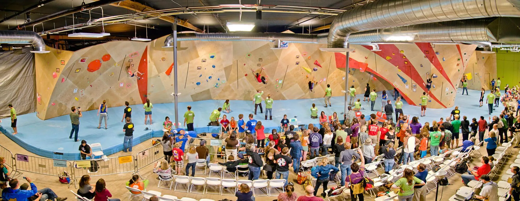 A wide angle view of the indoor bouldering walls built by Vertical Solutions. This climbing gym hosts comps as a way to increase their community outreach and give their customers a fun event to show off their skills.
