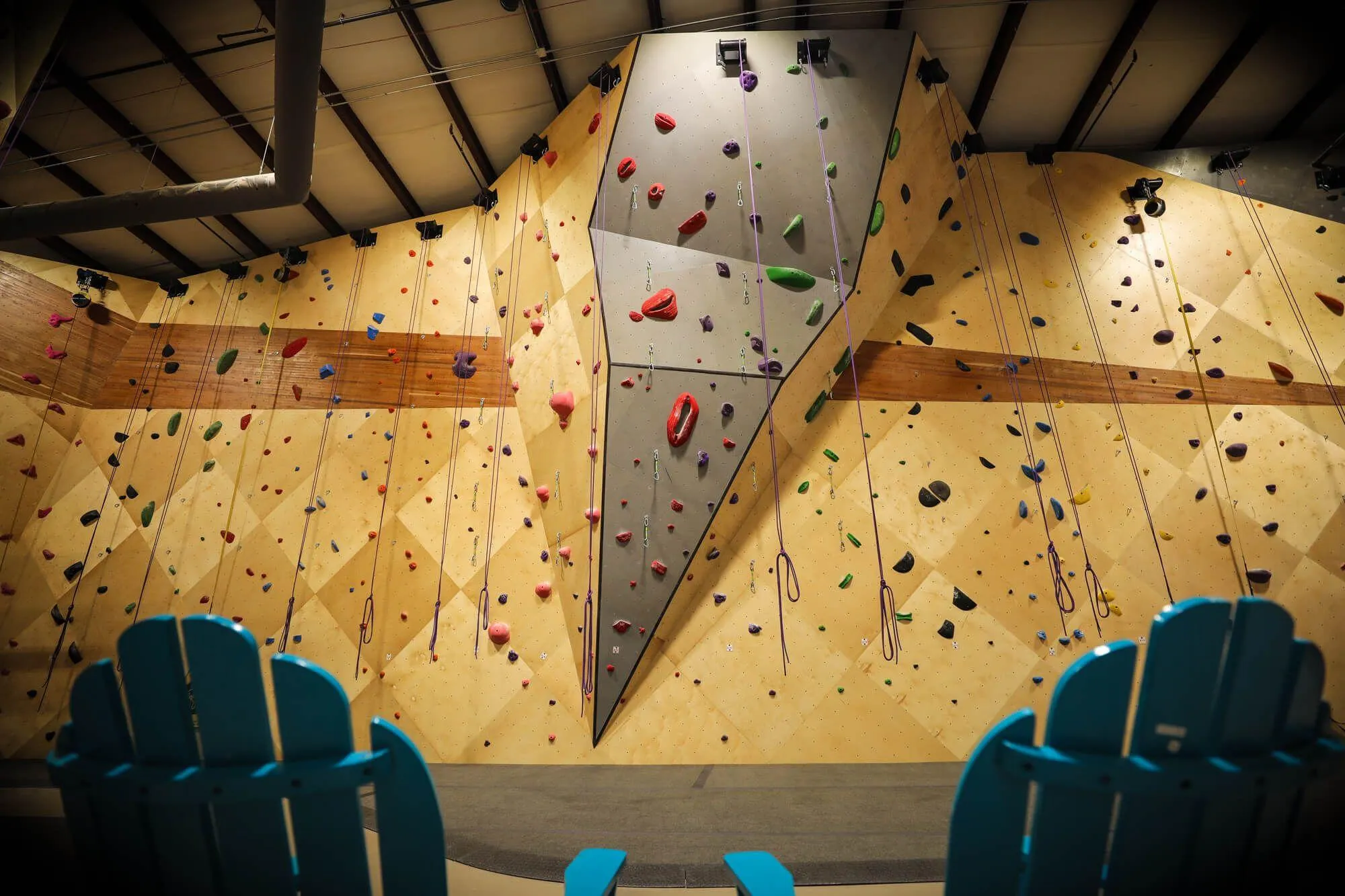 One of the first things that a climber will notice is how cohesive this entire indoor climbing gym is from walls to floors to retail. Everything was meticulously detailed, which meant the owners incorporating some massive hardwood inlays to make the space genuinely stunning visually.