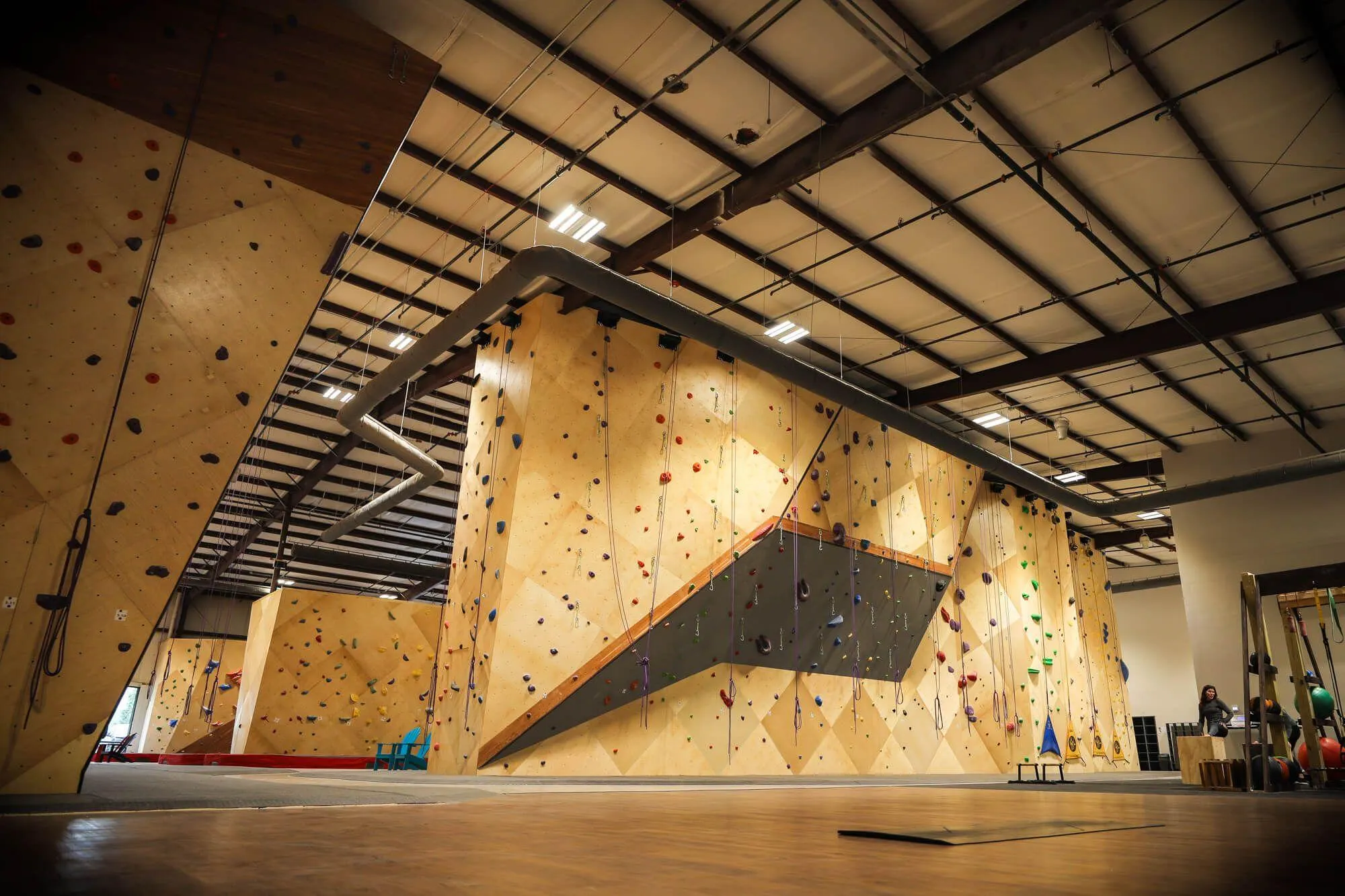 This image is taken from the ultra-clean yoga area and training space, and shows the backside of the main standalone route area. Not to be outdone, this backside features some challenging overhung lead climbing terrain itself, as well as 4 auto-belays.