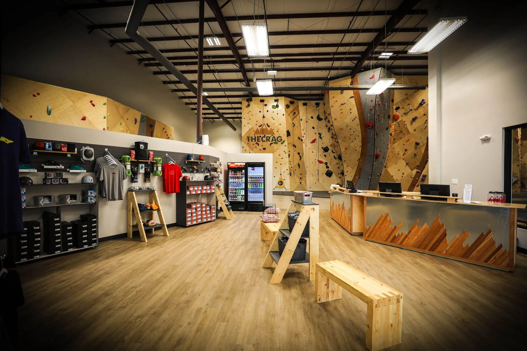 The first view you get upon entering the unassuming exterior of the facility. Branded throughout, customers are greeted with rich and warm woods, an open retail area to browse, a slick front desk to check-in at and one of the sexiest climbing walls just beyond that in the distance. Not entirely in-view are the three large windows on the right-hand wall which contribute to the open and airy feeling of this incredible indoor climbing gym.