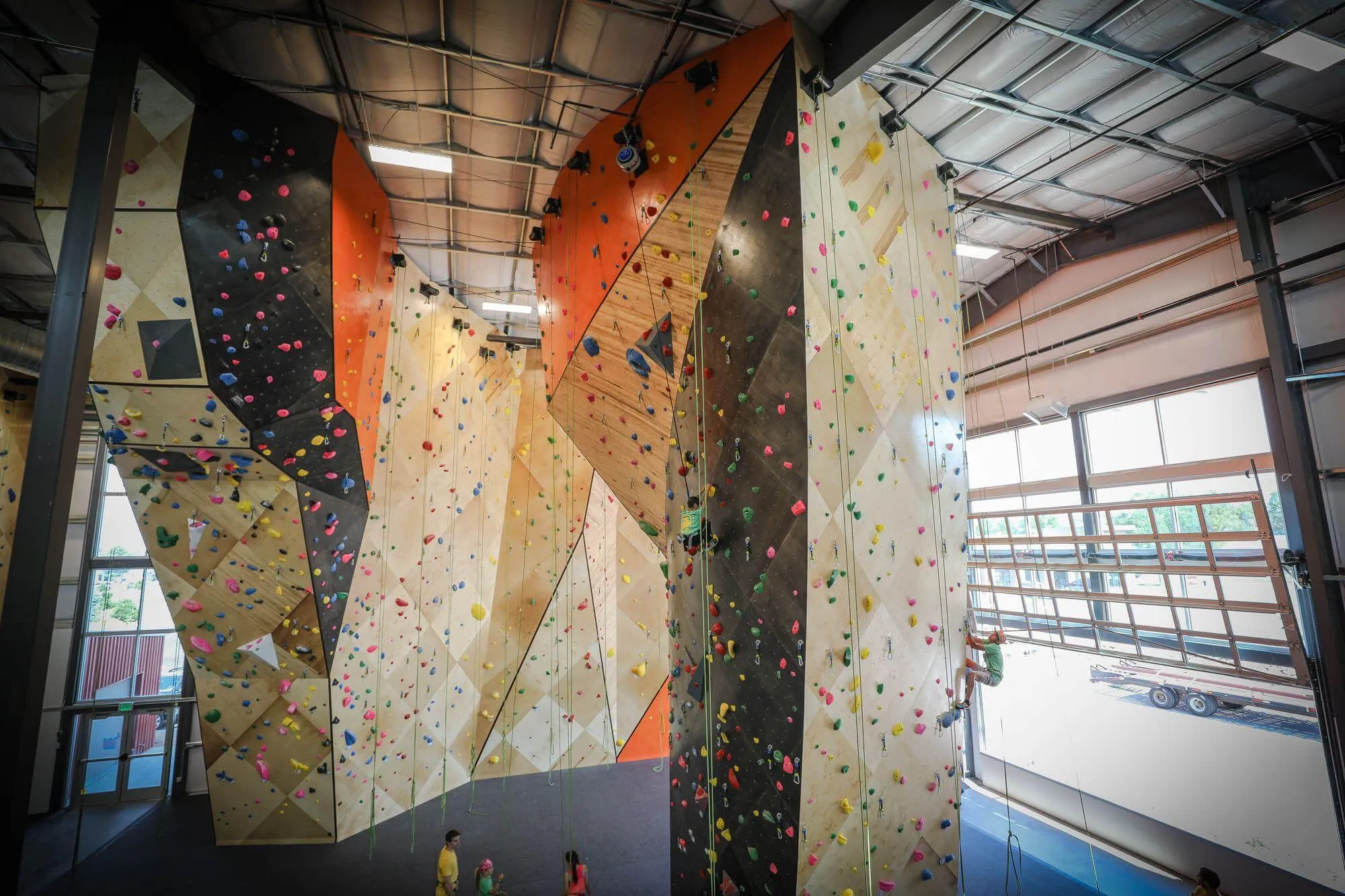 The upstairs view of The Spire curved climbing walls, and the much-welcomed link to the outdoors by way of large, transparent garage door.
