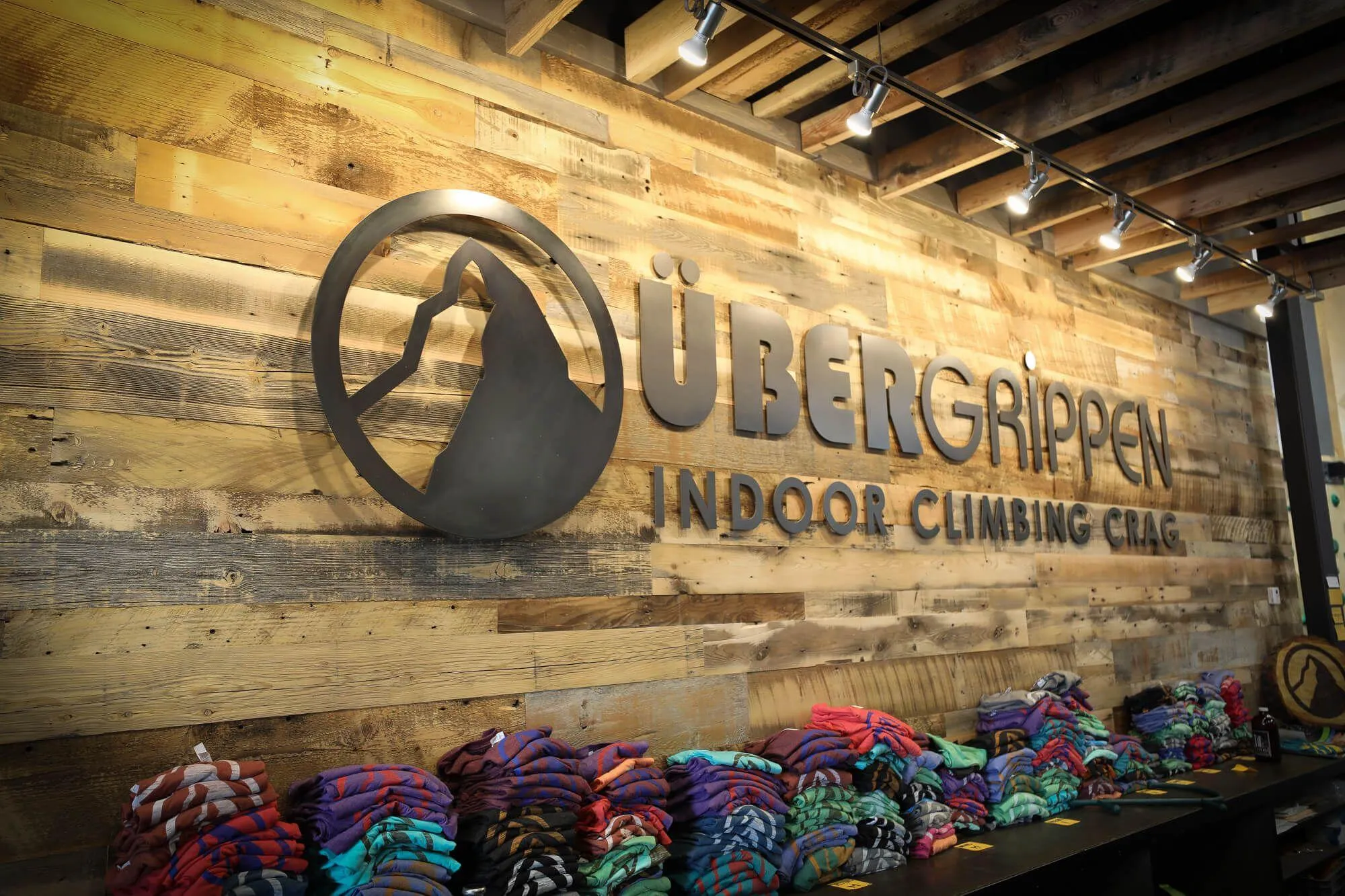 No detail was left unaddressed. The front entry area of this gym is 100% on-brand with the rich wood climbing walls throughout the entire facility, including this large laser-cut steel plate logo behind the front desk.
